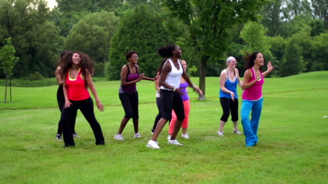 Group of diverse women dancing in a park