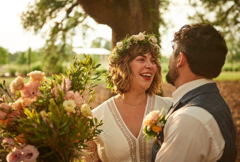 a couple celebrates their wedding under the oaks at moncus park