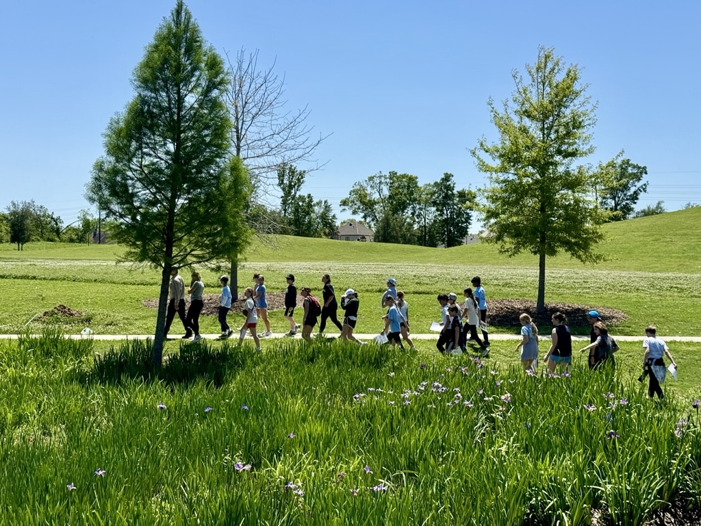 Grounds director leads a group of students on an educational tour at moncus park