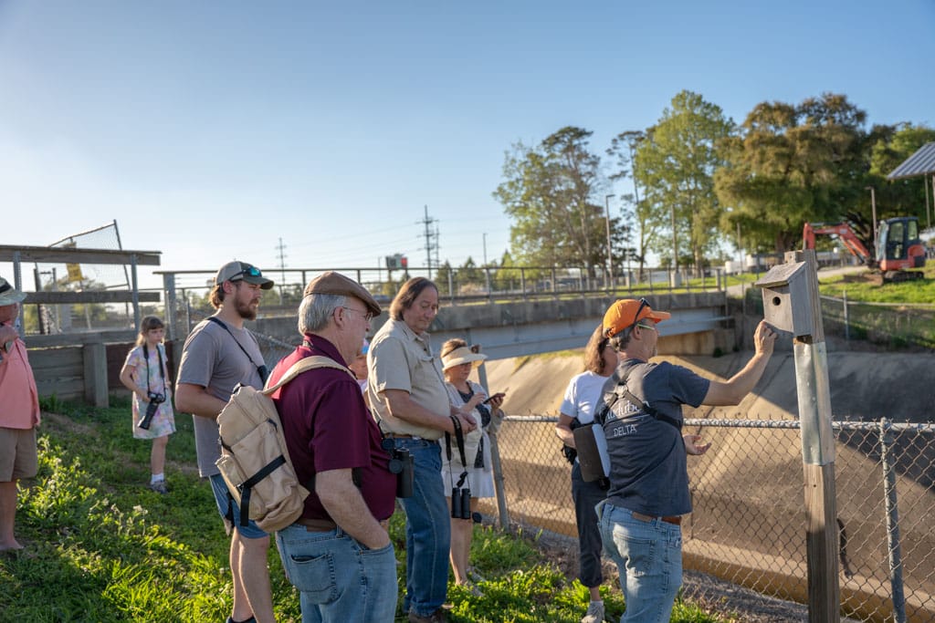 Bird walk guide leading a group at Moncus Park