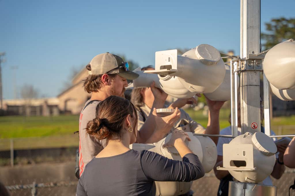 Bird watching group observing wildlife at Moncus Park