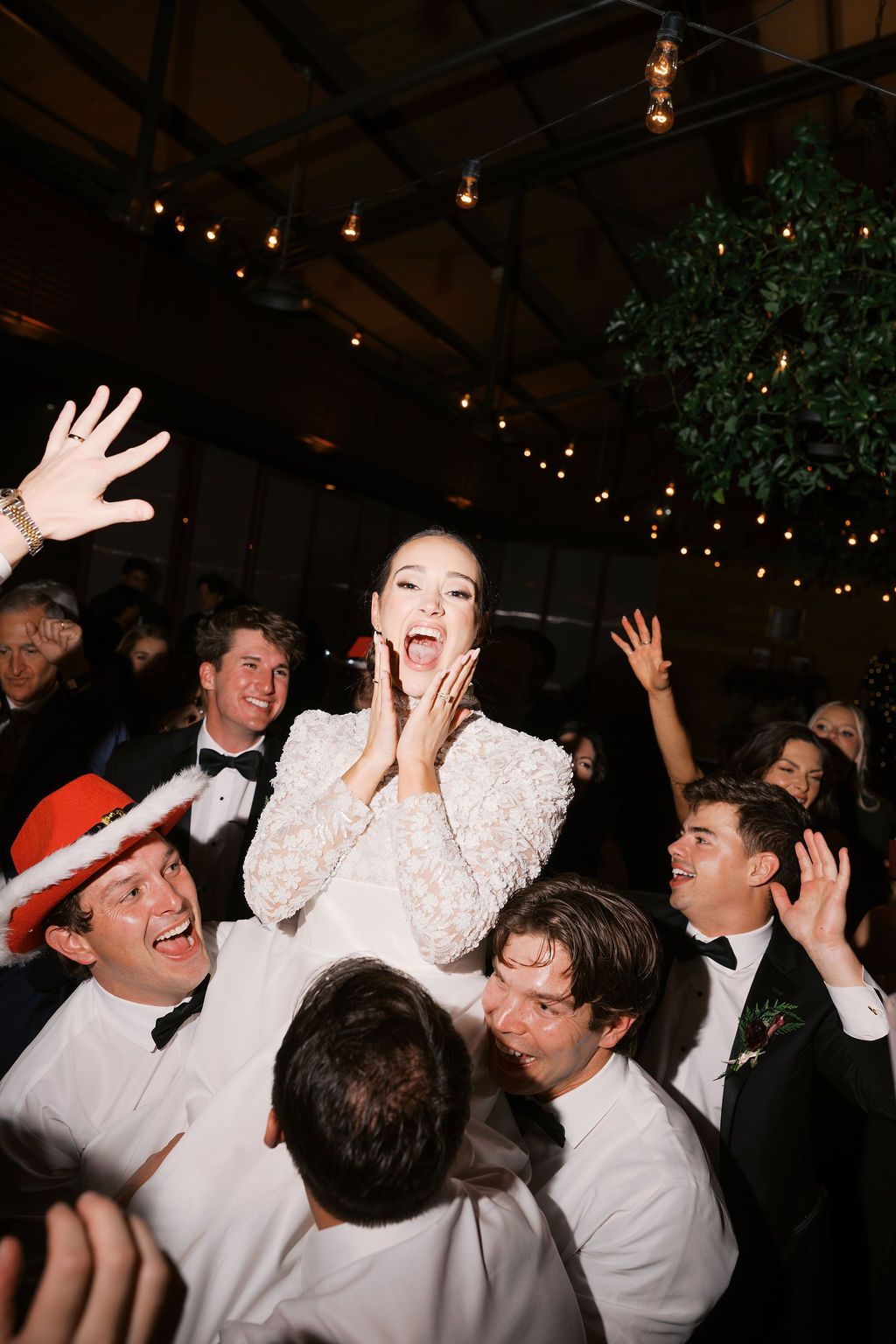 Moncus Park Christmas wedding: bride lifted by groomsmen in celebration at the reception
