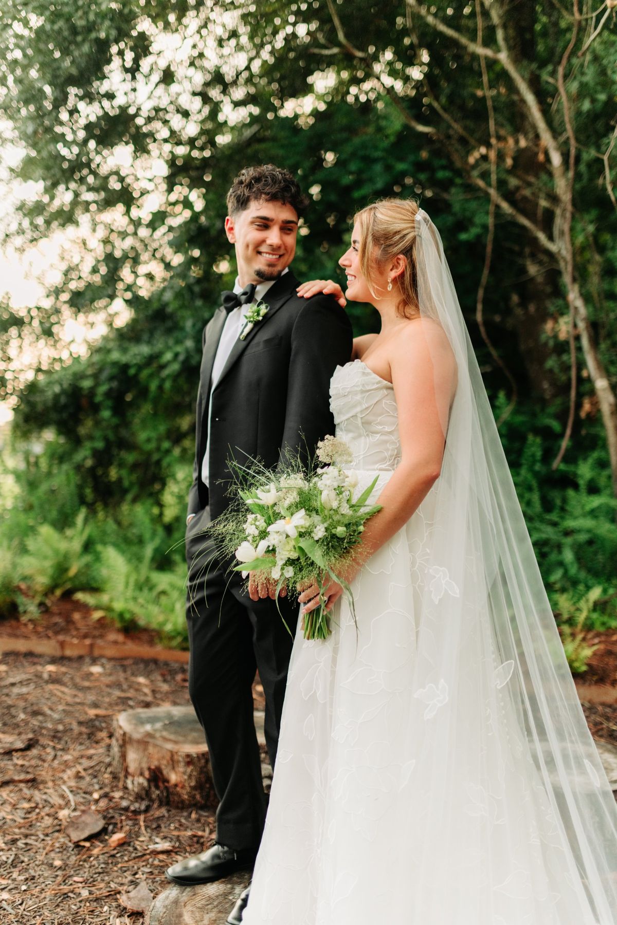 Moncus Park: couple posing in the garden, bride holding a white bouquet