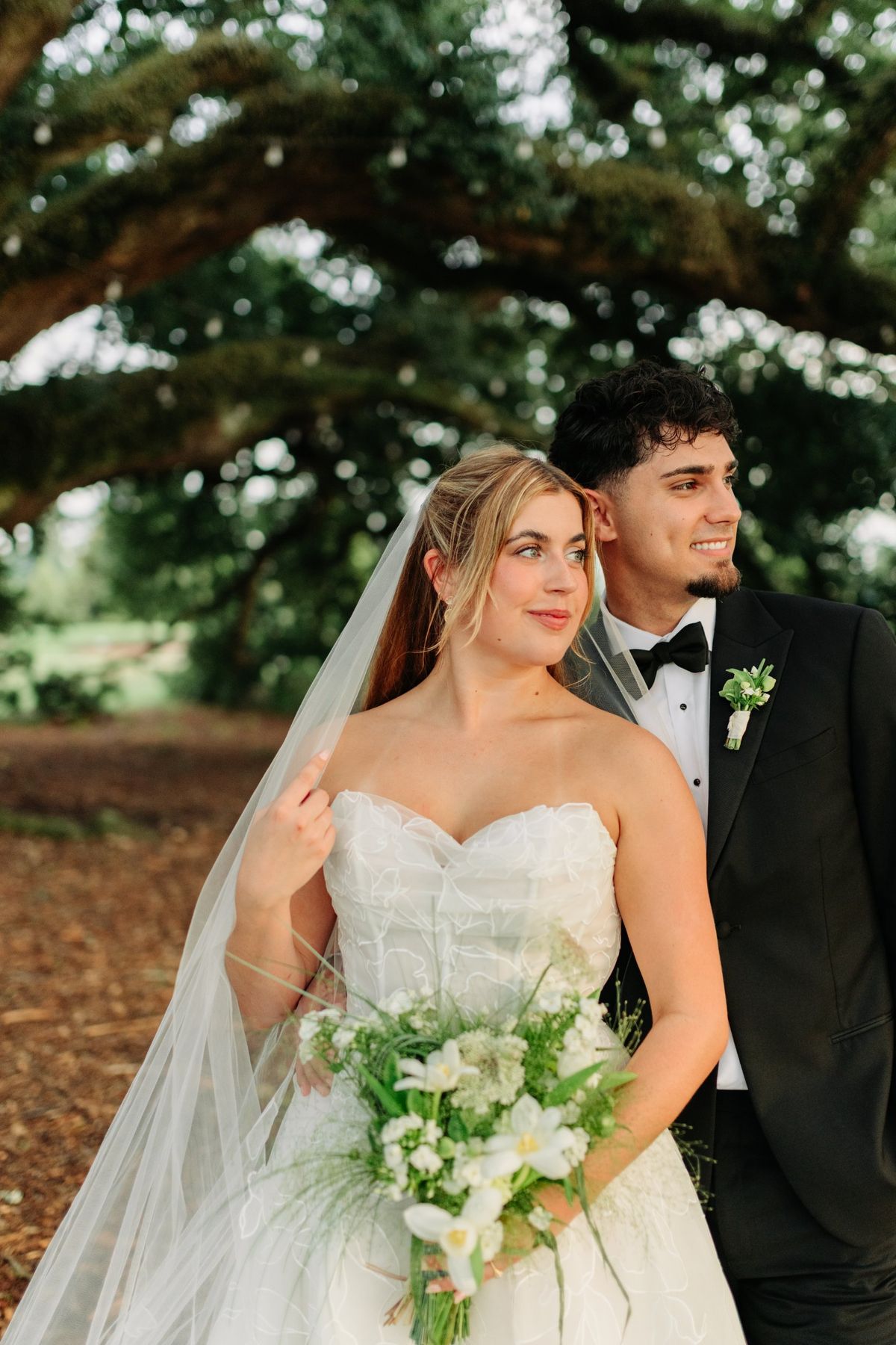 Moncus Park: couple posing under a live oak hung with string lights