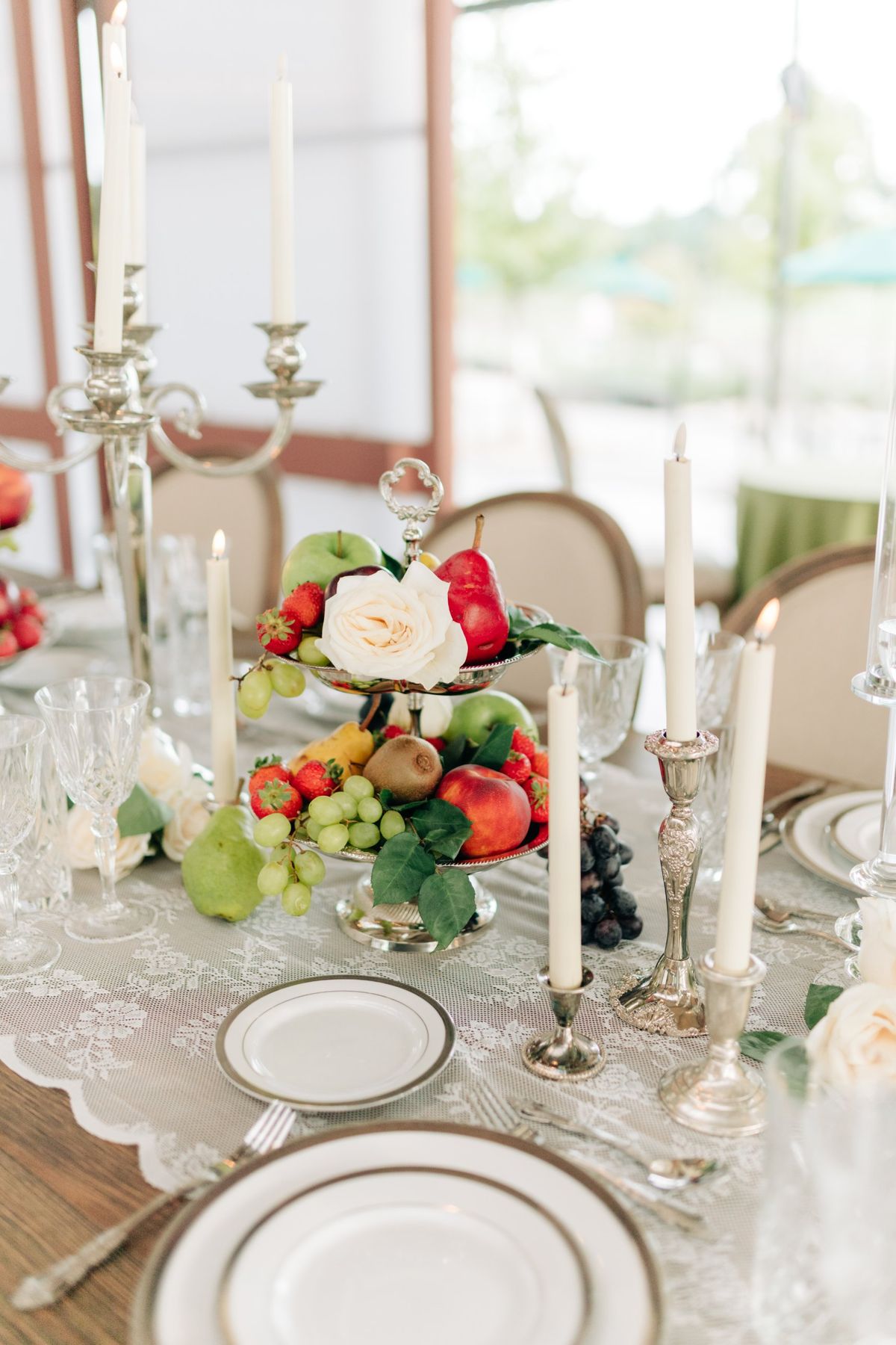 Moncus Park: tiered fruit centerpiece with silver candlesticks and a lace table runner