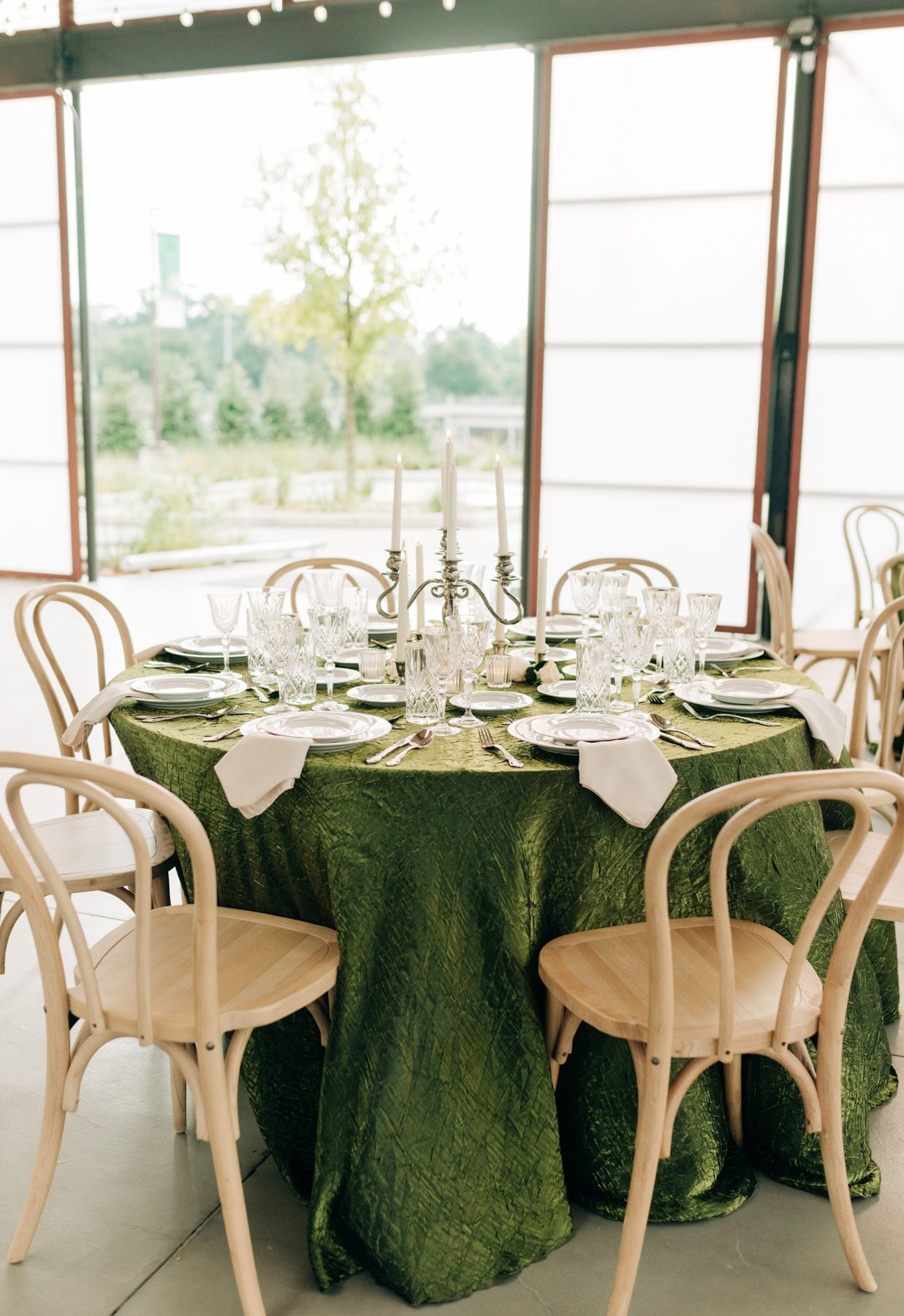 Moncus Park: round table with green velvet linen, silver candelabra, and crystal glassware in the Doerle Pavilion