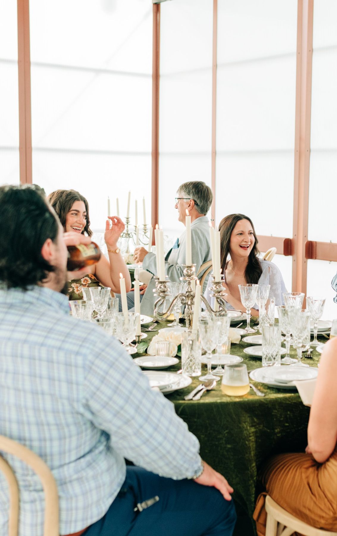 Moncus Park: guests laughing together at a candlelit reception table in the Doerle Pavilion